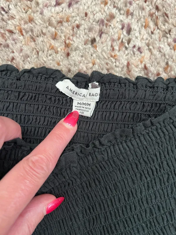 Black smocked crop top featuring dramatic puff sleeves with textured embroidery. Square neckline and fitted bodice create a flattering silhouette. Easy to style for casual or dressed-up looks. American Eagle size medium - Image 5