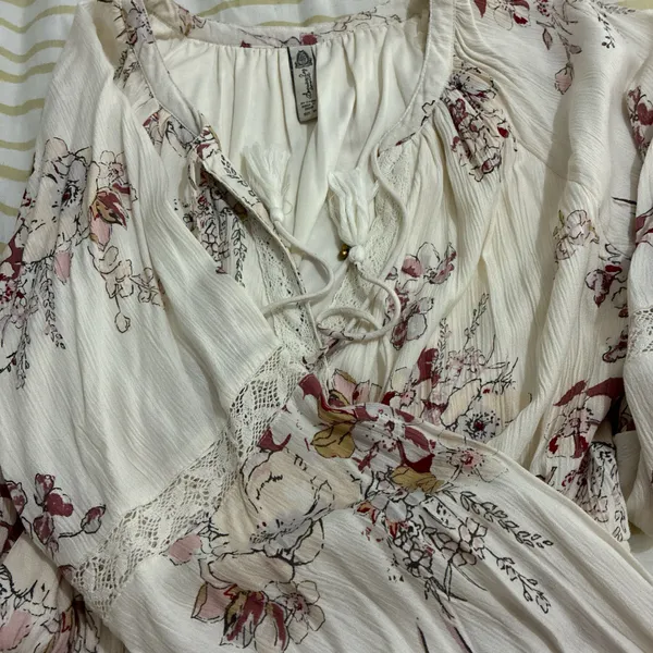 The American Rag Long Sleeve Lace Up Bodice Floral Dress in Cream is a stylish and versatile option for women. This fit & flare dress features a floral pattern in cream, pink, and white, making it perfect for various occasions such as travel, weddings, parties, or casual outings. The long sleeves and lace-up bodice add a touch of elegance, while the short dress length adds a trendy flair. Made from a blend of rayon, cotton, polyester, and linen, this dress offers both comfort and style for women in size M. - Image 5