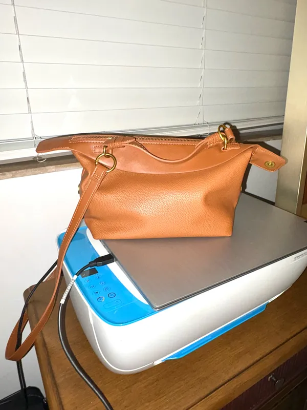 The Free Assembly brown bag features a faux leather structure with top handles and a removable crossbody strap. - Image 5