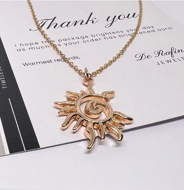 Gold Sun swirl charm necklace - Image 2