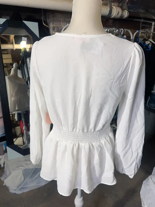 LOS ANGELES white lace V-neck long sleeve shirt top peplum tie cuff New with tag Smoke and pets free Same day shipping Elevate your wardrobe with this stunning white lace blouse from . The V-neckline and long sleeves add a touch of elegance to this top, while the peplum and tie cuff details create a flattering silhouette. The angel character and rose theme make it perfect for any occasion, from casual outings to formal events. Crafted from high-quality lace fabric, this blouse features adjustable features and is available in size S. The solid pattern and delicate lace accents make it a versatile piece that can be paired with any bottom. Whether you're dressing up or down, this Rose & Grey blouse is sure to turn heads. - Image 4