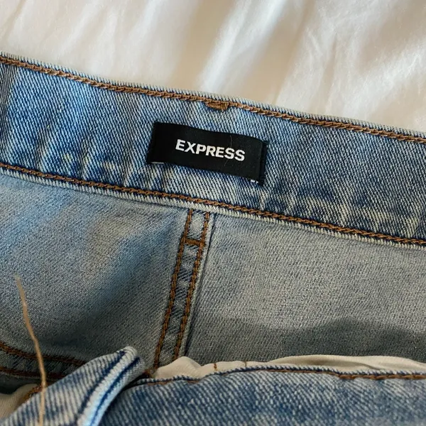 Express Super High Waisted Light Wash Raw Hem Slim Jeans - Image 2