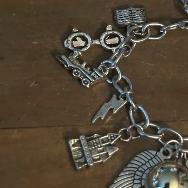 Silver tone charm bracelet with assorted charms - Image 5