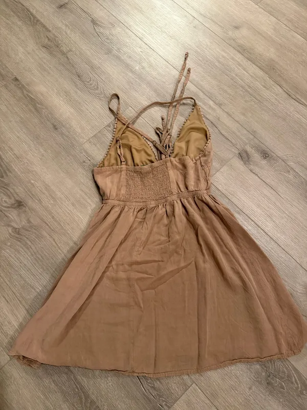 Wild Fable Tan Pom-Pom Trim Mini Dress - Size XS Get ready for sun-drenched days with this adorable Wild Fable mini dress. Featuring a neutral tan hue, this piece stands out with its delicate pom-pom trim along the neckline and a boho-inspired lace-up front with tassel details. The smocked waist ensures a flattering, flexible fit, while the lightweight fabric makes it perfect for beach trips or brunch. • Condition: Like new / Excellent • Size: Women’s XS • Style: Halter neckline with adjustable spaghetti straps • Color: Tan/Beige Smoke-free home. Fast shipping! - Image 2