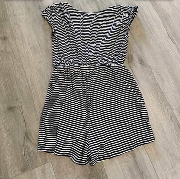 Urban Outfitters Striped Romper - Excellent Condition - Women’s Size M Description: Upgrade your casual wardrobe with this effortless Urban Outfitters striped knit romper! Made in the USA, this stylish piece features a classic navy and white nautical stripe pattern with a flattering deep V-neckline, soft cap sleeves, and a comfortable cinched elastic waistband. Crafted from a soft, lightweight stretch fabric, it’s perfect for summer outings, beach cover-ups, or casual weekend wear. Brand: Urban Outfitters Size: Women’s Medium (M) Condition: Excellent, like-new condition with no visible flaws, stains, or excessive wear. Details: Elasticized waist, short inseam, breathable stretch material, made in USA. Fast shipping from a smoke-free home! Feel free to drop a comment with any questions or send reasonable offers. - Image 5