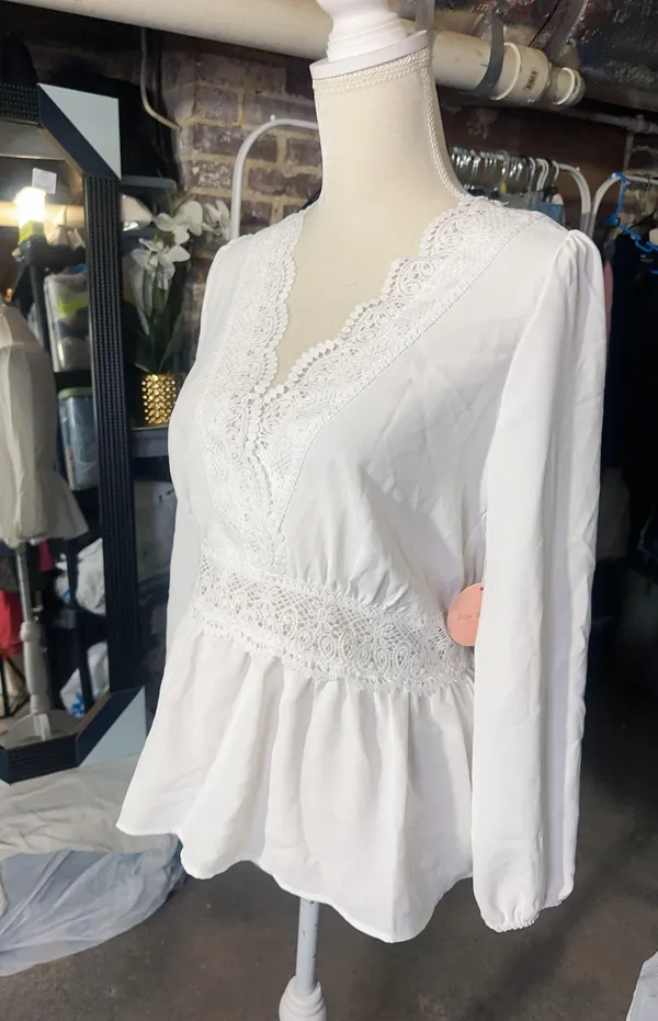 LOS ANGELES white lace V-neck long sleeve shirt top peplum tie cuff New with tag Smoke and pets free Same day shipping Elevate your wardrobe with this stunning white lace blouse from . The V-neckline and long sleeves add a touch of elegance to this top, while the peplum and tie cuff details create a flattering silhouette. The angel character and rose theme make it perfect for any occasion, from casual outings to formal events. Crafted from high-quality lace fabric, this blouse features adjustable features and is available in size S. The solid pattern and delicate lace accents make it a versatile piece that can be paired with any bottom. Whether you're dressing up or down, this Rose & Grey blouse is sure to turn heads. - Image 2
