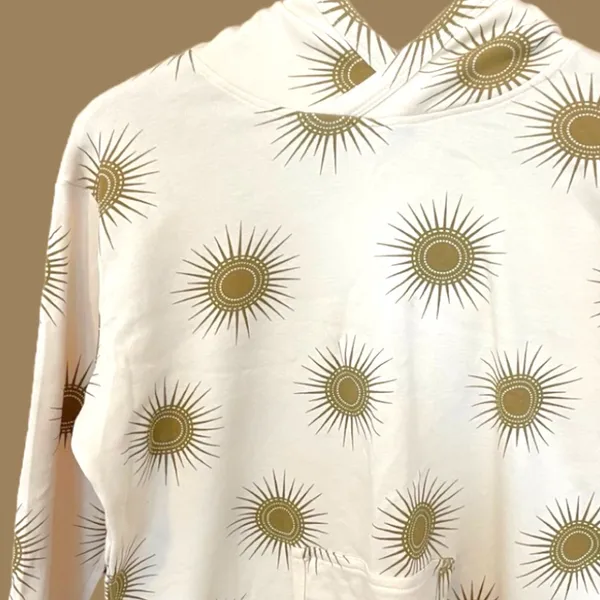 Kate Quinn Cream Hoodie with Gold Sunburst Pattern - Image 3