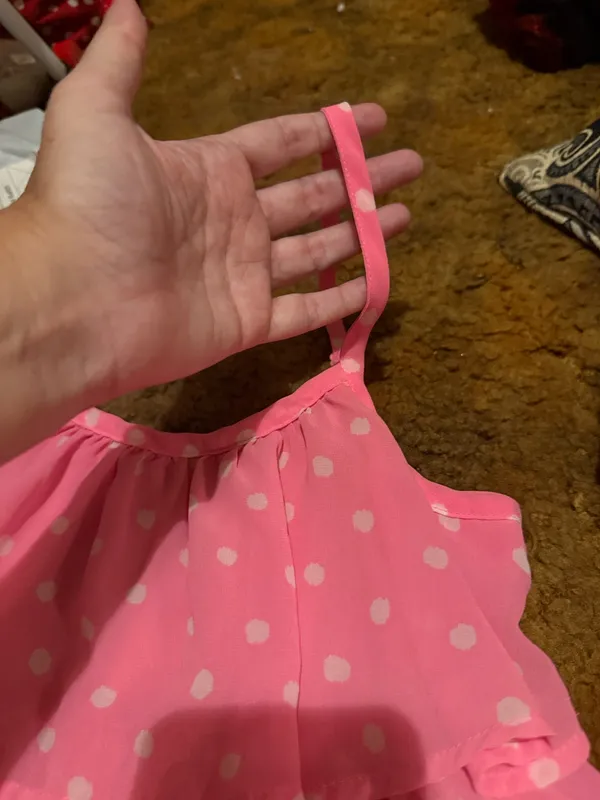Lightweight pink tank with white polka dots. Features layered ruffle tiers and thin adjustable straps. Flows and feminine silhouette. Great for warm-weather styling. - Image 4