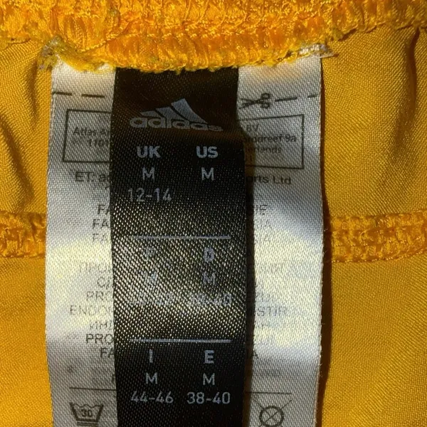 yellow Adidas athletic shorts white side panels black logo women’s medium - Image 2