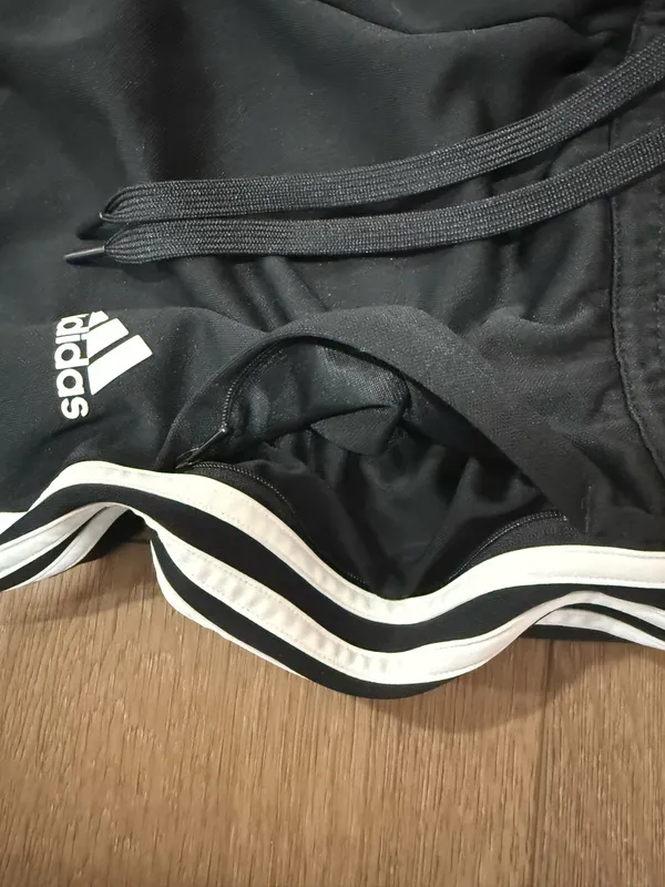 Black Adidas zip-leg joggers with pockets and drawstrings - Image 3