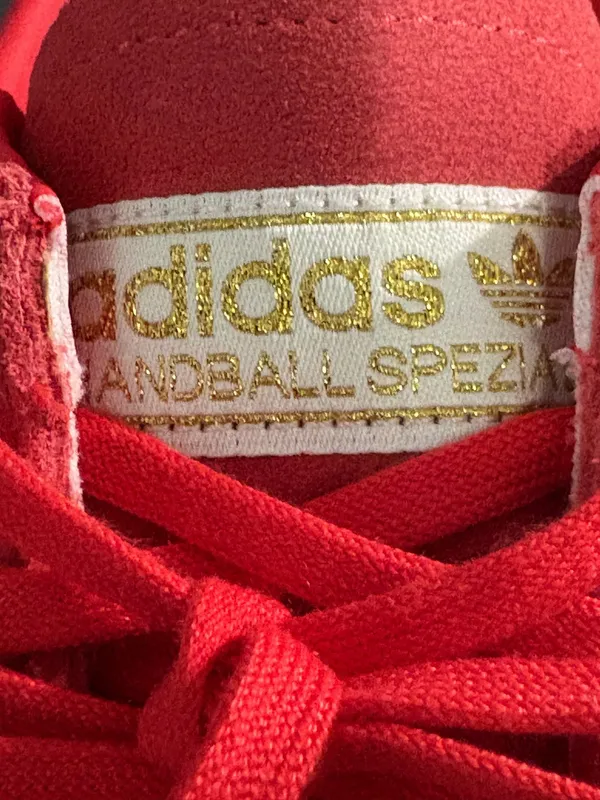 Adidas handball poles in a pretty red with light orange stripes - Image 7