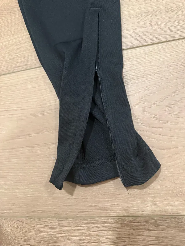 Black Adidas zip-leg joggers with pockets and drawstrings - Image 2