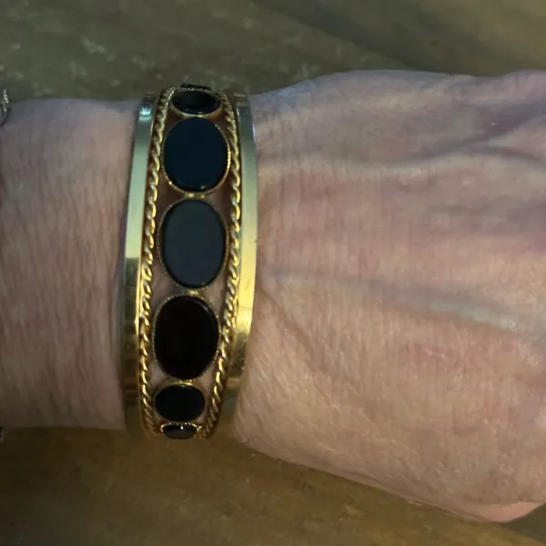 Gold tone open hinged bangle with oval black stones - Image 2