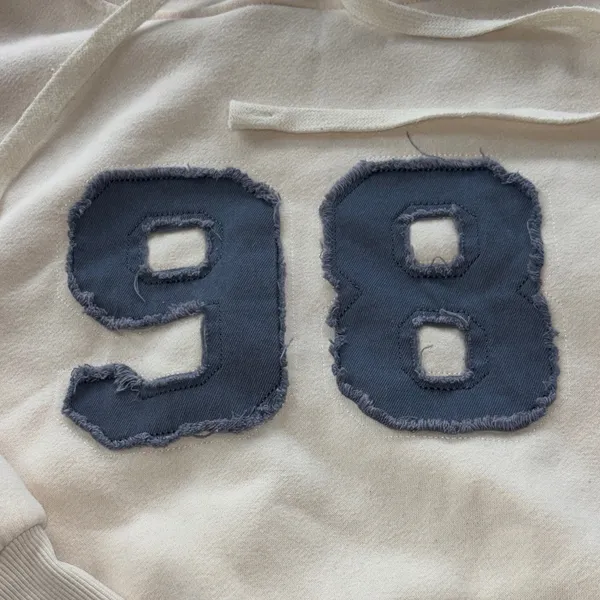 Edikted Cream Crewneck Hoodie with Distressed Blue '98' Patch - Image 2