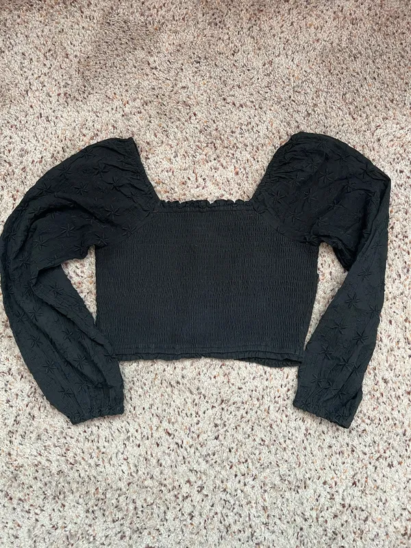 Black smocked crop top featuring dramatic puff sleeves with textured embroidery. Square neckline and fitted bodice create a flattering silhouette. Easy to style for casual or dressed-up looks. American Eagle size medium - Image 2
