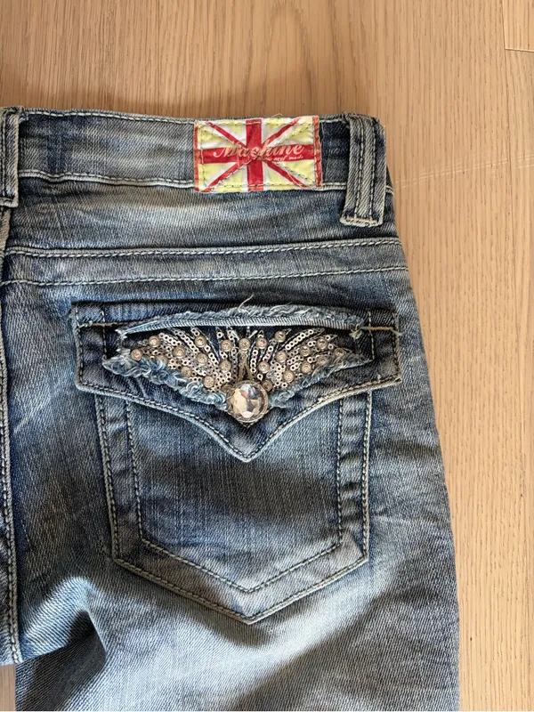 Machine distressed crystal embellished low rise denim jeans - Image 11