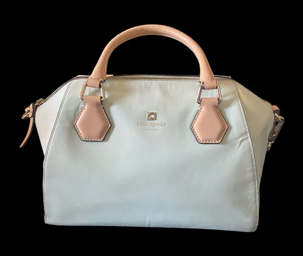 Kate Spade NEW YORK-MINT MOJITO PIPPA PARNELL STREET LEATHER SATCHEL Perfect spring bag, mint green white tan handle and crossbody strap, top zip closure, stripe print interior, inside zip pocket, inside two open pockets, amazing condition, there are two call outs, a small smudge on the bottom of the bag and a small smudge on one corner, please see the last two pictures **This bag is preowned and is being sold as is** - Image 5
