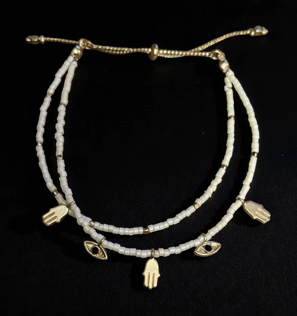 White beaded bolo bracelet with hamsa and evil eye charms - Image 2