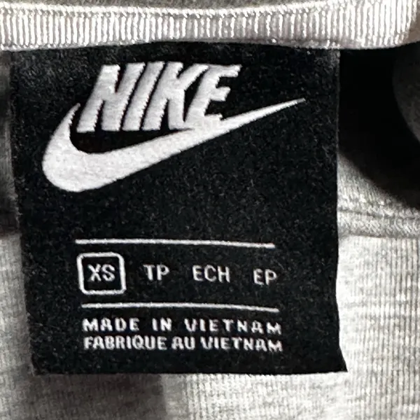 Nike Gray Minimalist Hoodie XS Y2K Athleisure Streetwear Description: Soft gray Nike hoodie with embroidered logo and kangaroo pocket. Perfect minimalist, gorpcore, streetwear, gym, and casual layering essential. Pre-owned Condition: Excellent Flaws: No significant flaws observed. Stored: Model created by AI. NikeHoodie Streetwear Athleisure MinimalistStyle Gorpcore HeatherGray Pullover LogoHoodie Layering Y2K - Image 4