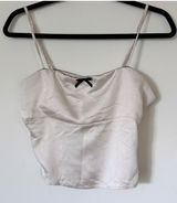 Elegant Cream Satin Camisole Top with Black Bow Accent Photo 0