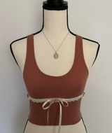 terracotta rust tank with white lace, three mauve pink rosebuds, & a white ribbon bow 🌷🤍✨ Photo 0