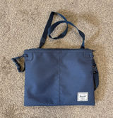 Herschel navy blue crossbody bag with red/white striped lining Photo 0