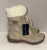 U.S. Polo Assn. Women's Yvonne Snow Boots in an "Oatmeal" or beige colorway. These mid-calf winter boots feature a duck-toe rubber shell base for slush protection, a quilted canvas shaft, traditional lace-up closure, and a plush faux-fur collar trim. A signature metallic logo plaque is attached to the side strap Photo 0