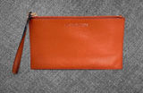 Michael Kors Orange Pebbled Leather Zip Wristlet Clutch Photo 0