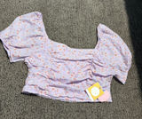 Story On Purple Floral Top Photo 0