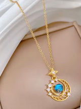 This gold-plated necklace features a celestial-themed pendant with a blue gem representing a planet surrounded by a crescent moon. Photo 0