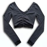 Black Long Sleeve V-Neck Ruched Crop Top with Lace Trim Hem and Cuffs Photo 0
