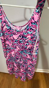 Lilly Pulitzer Romper - Size M Authentic Lilly Pulitzer - Made in China Size: Medium Print: Vibrant abstract in Hot Pink, Navy, Teal / Aqua - Flamingo / shell print - so cute! Style: Sleeveless tank romper, scoop neck, smocked / elastic waist with gold drawstring, shorts bottom show less Photo 0